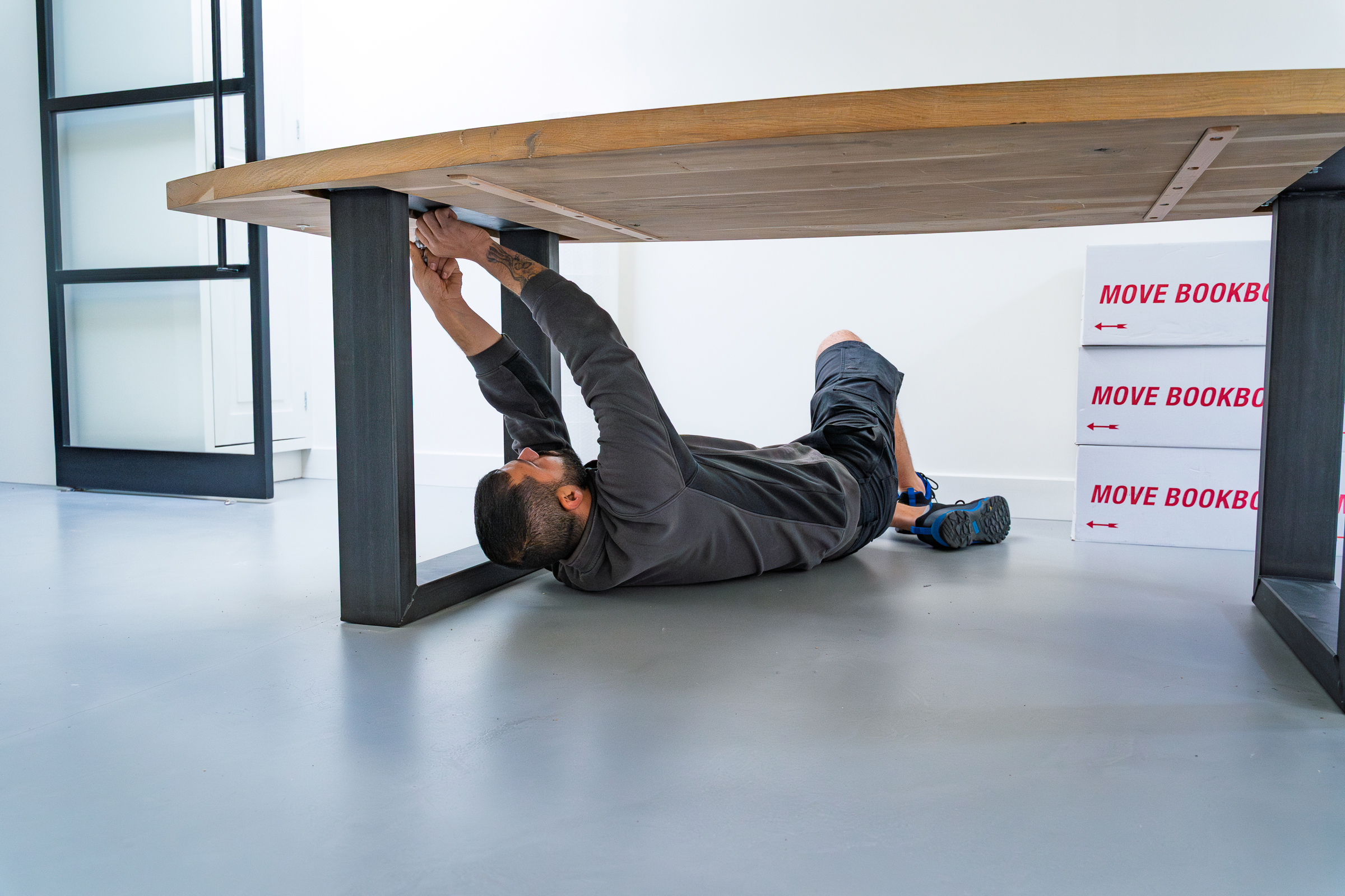 Verhuizer demonteert een grote tafel voor de verhuizing
